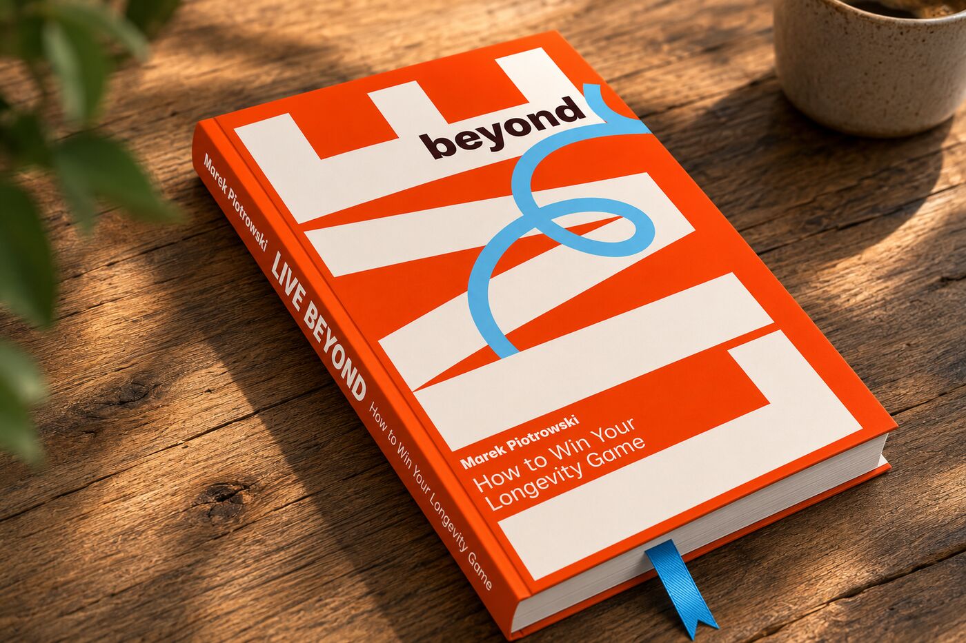 Live Beyond — How to Win Your Longevity Game. The book with its blue ribbon, on the table.