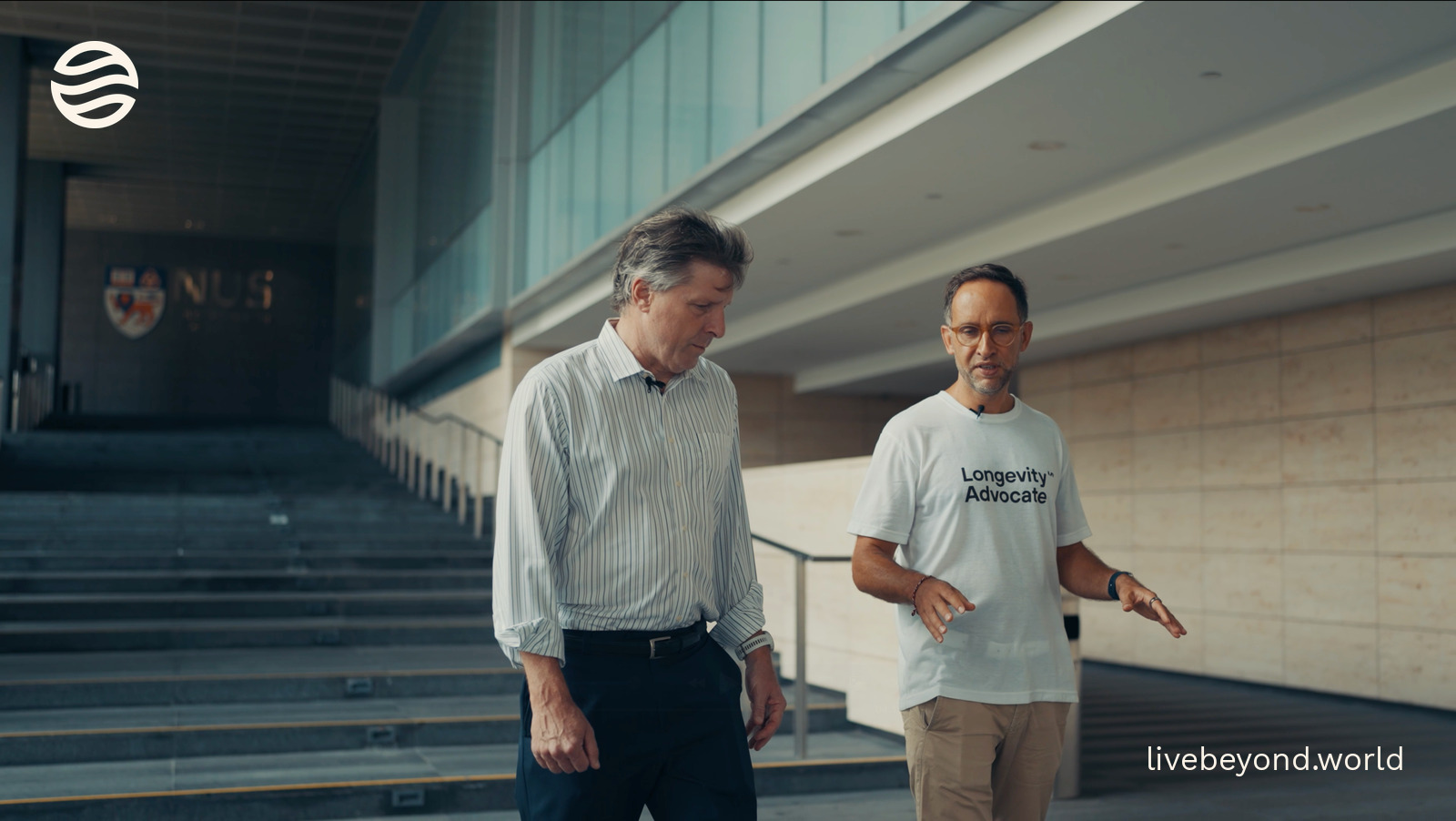 Brian Kennedy and Marek walking and talking outside a university building.