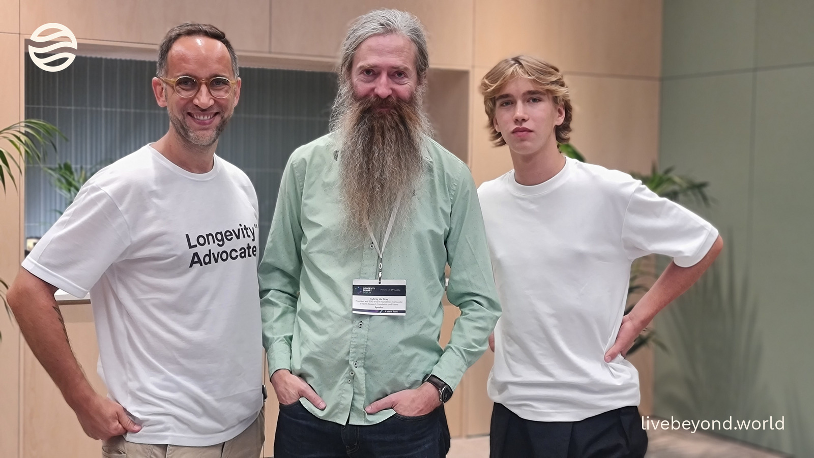 Marek, Aubrey de Grey and Alek standing side by side, smiling, in an interview room in Dublin.