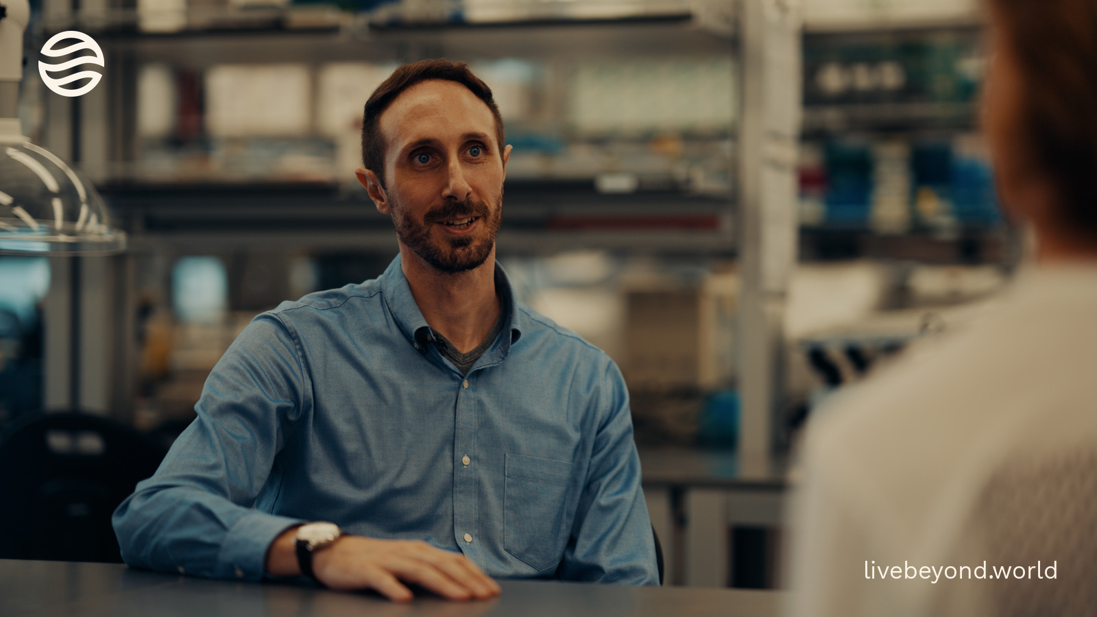 Vincenzo Sorrentino smiling at a table in his laboratory.
