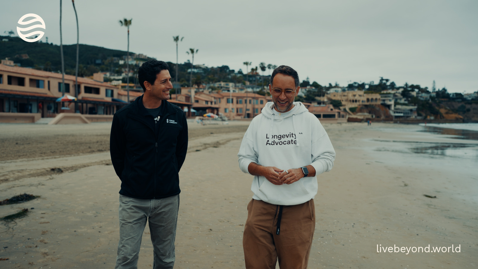 Eric Dinenberg and Marek standing on a sandy beach in San Diego.