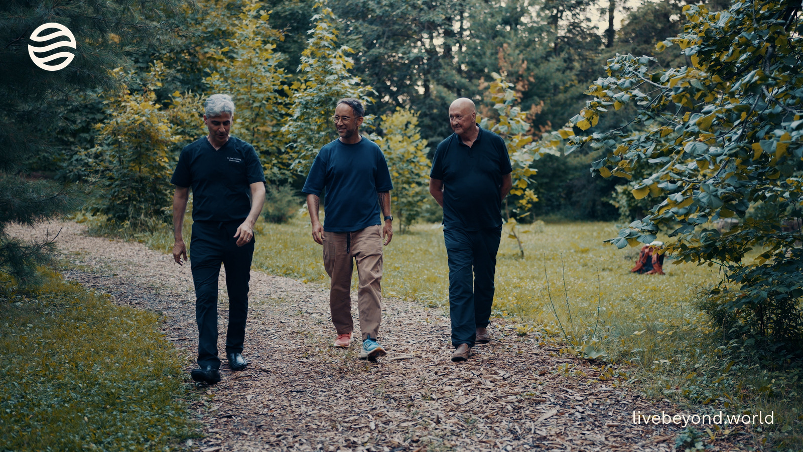 John Davies, Marek and Cory Goldberg walking along a path through the woods.