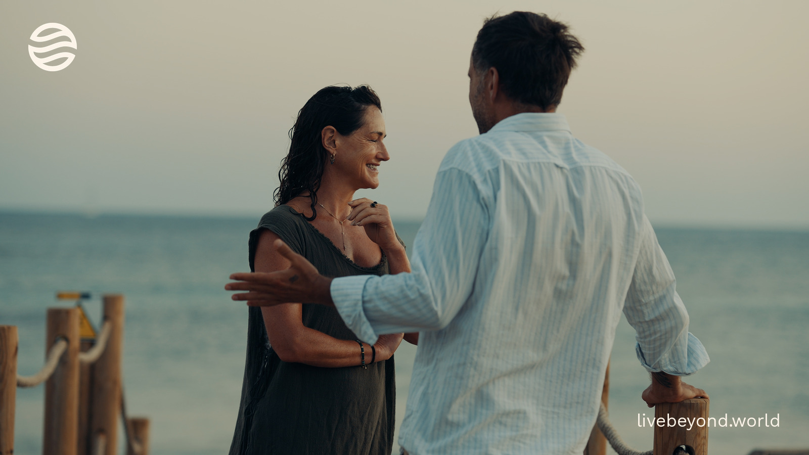 Dr Tamsin Lewis smiling as she talks with Marek by the sea in Formentera.