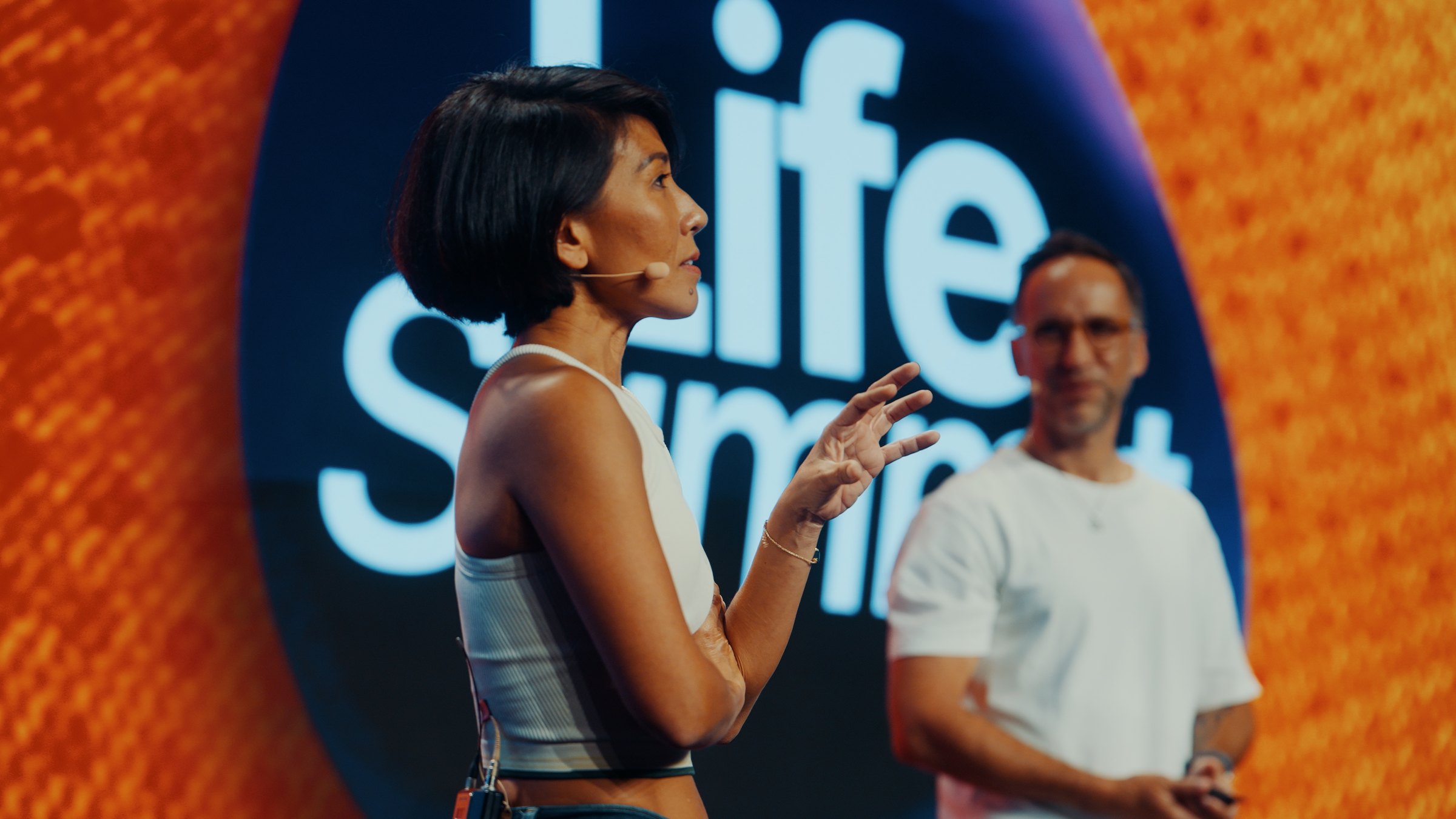 Marek and Olivia Lesslar on stage at Life Summit Berlin, May 2026.