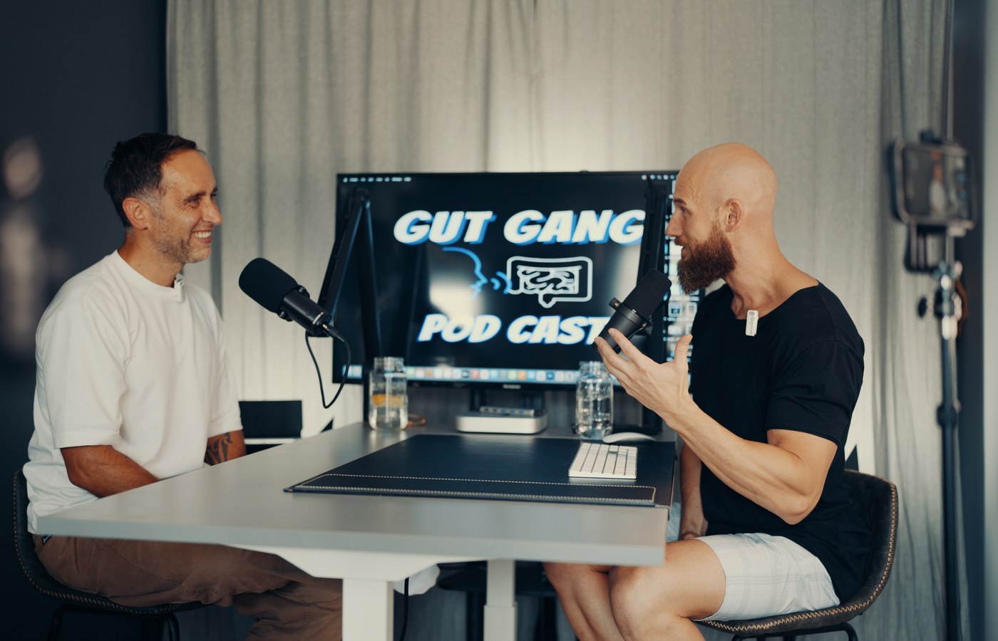 Brendan Coates and Marek recording at the Gut Gang podcast desk in Toronto