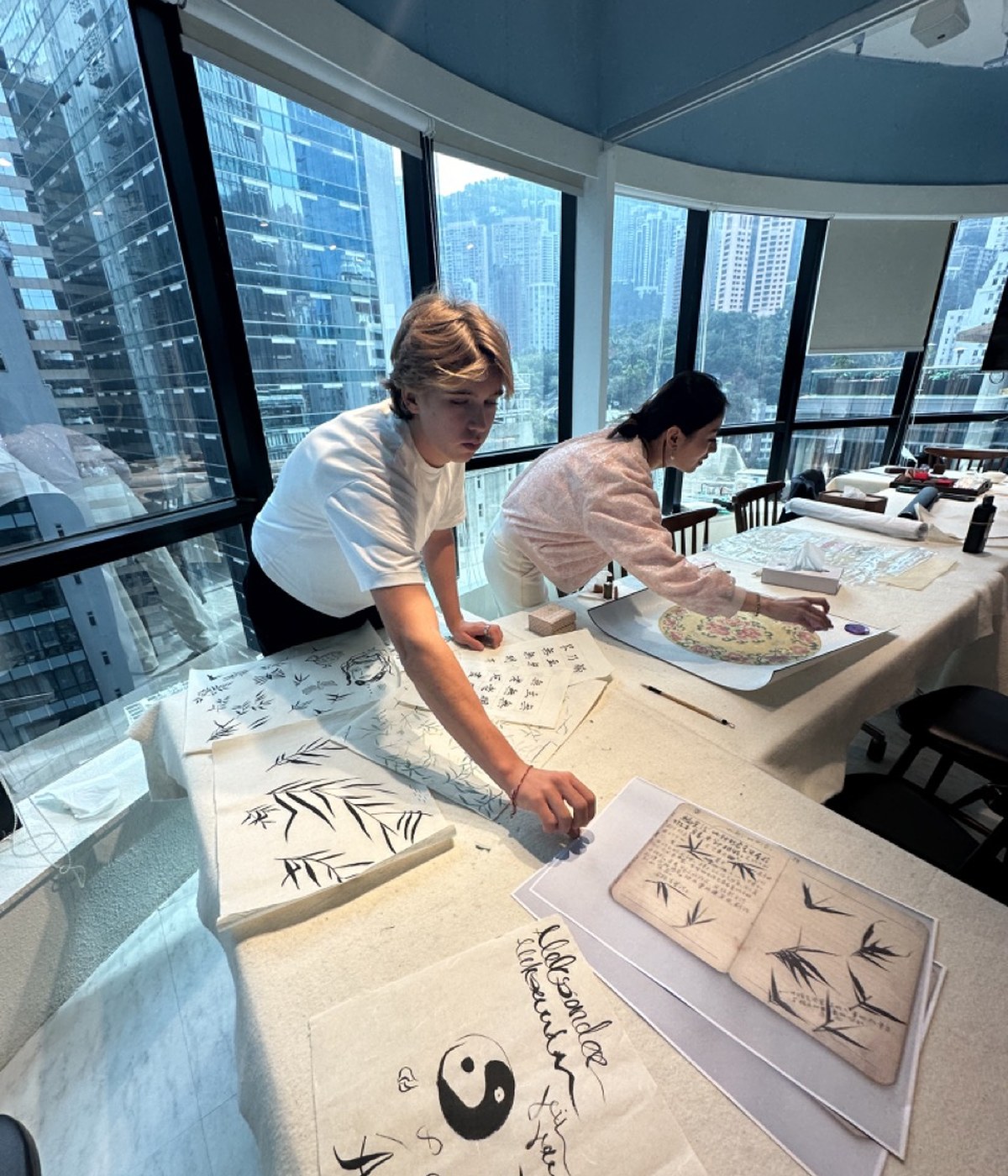 Aleksander and Christine Yuan Huang doing Chinese brush painting in Hong Kong