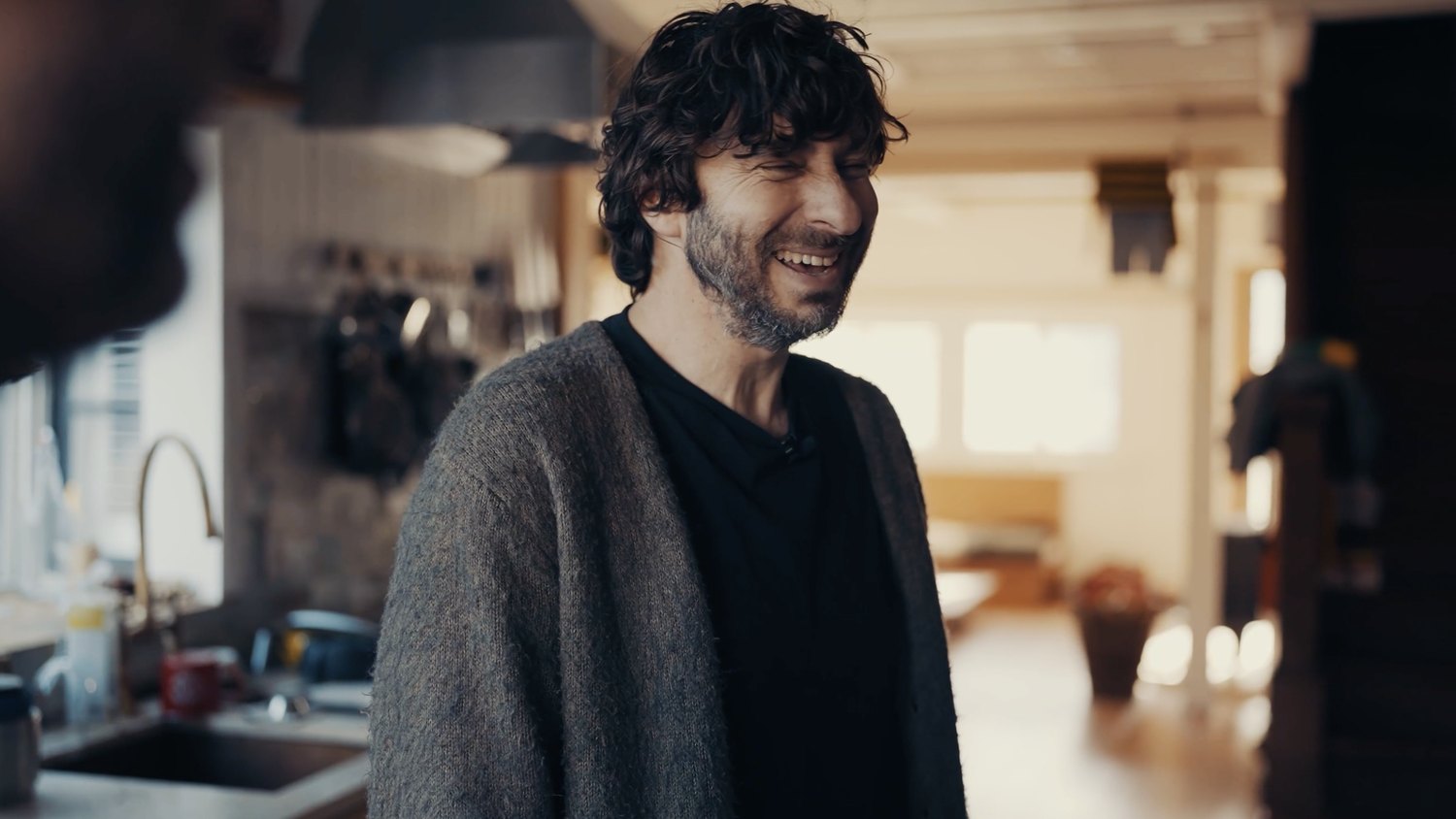 David Furman laughing in his kitchen at home in San Francisco