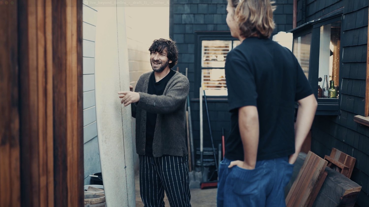 David Furman and Aleksander Piotrowski by the surfboards outside his home