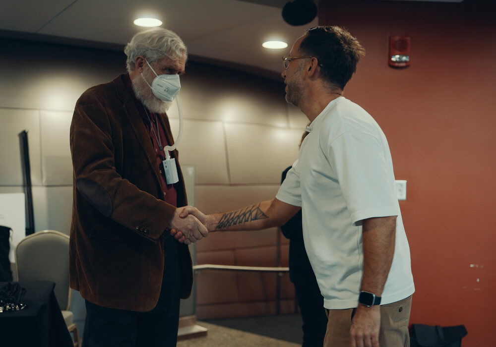 George Church greeting Marek at the biomarkers conference in Boston