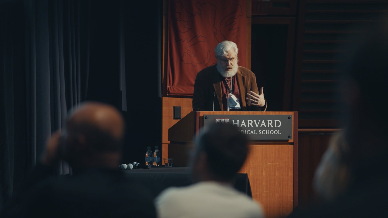 George Church speaking on stage at the Biomarkers of Aging conference, Harvard 2024