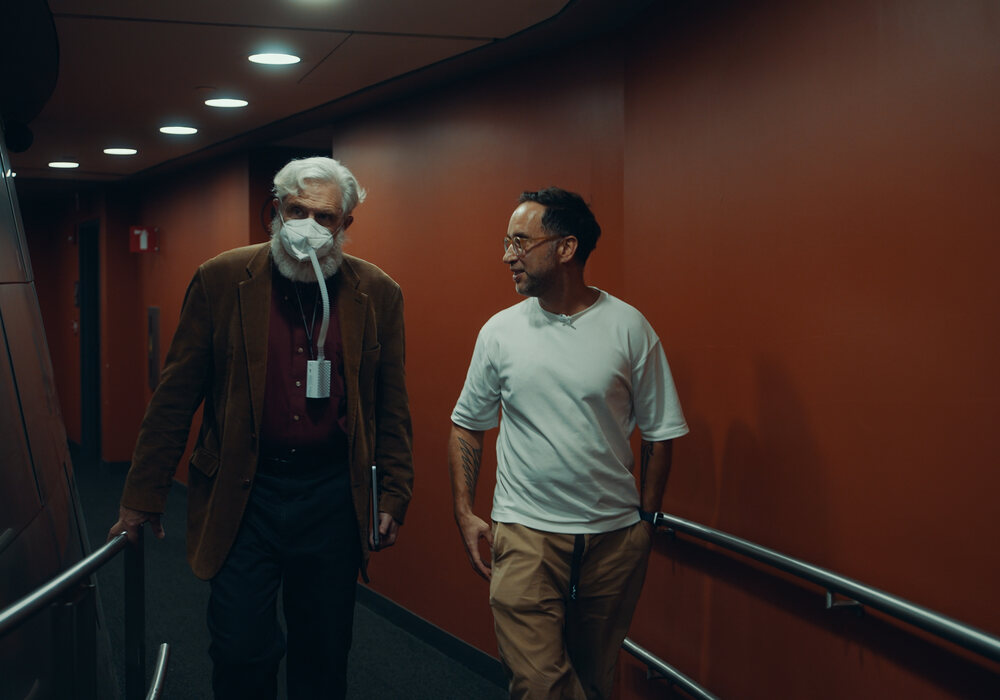 George Church walking through the halls after his lecture in Boston