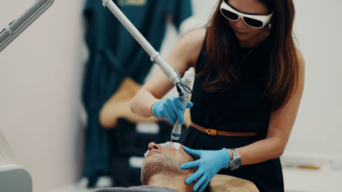 Kathryn Koh performing a laser skin treatment on Marek