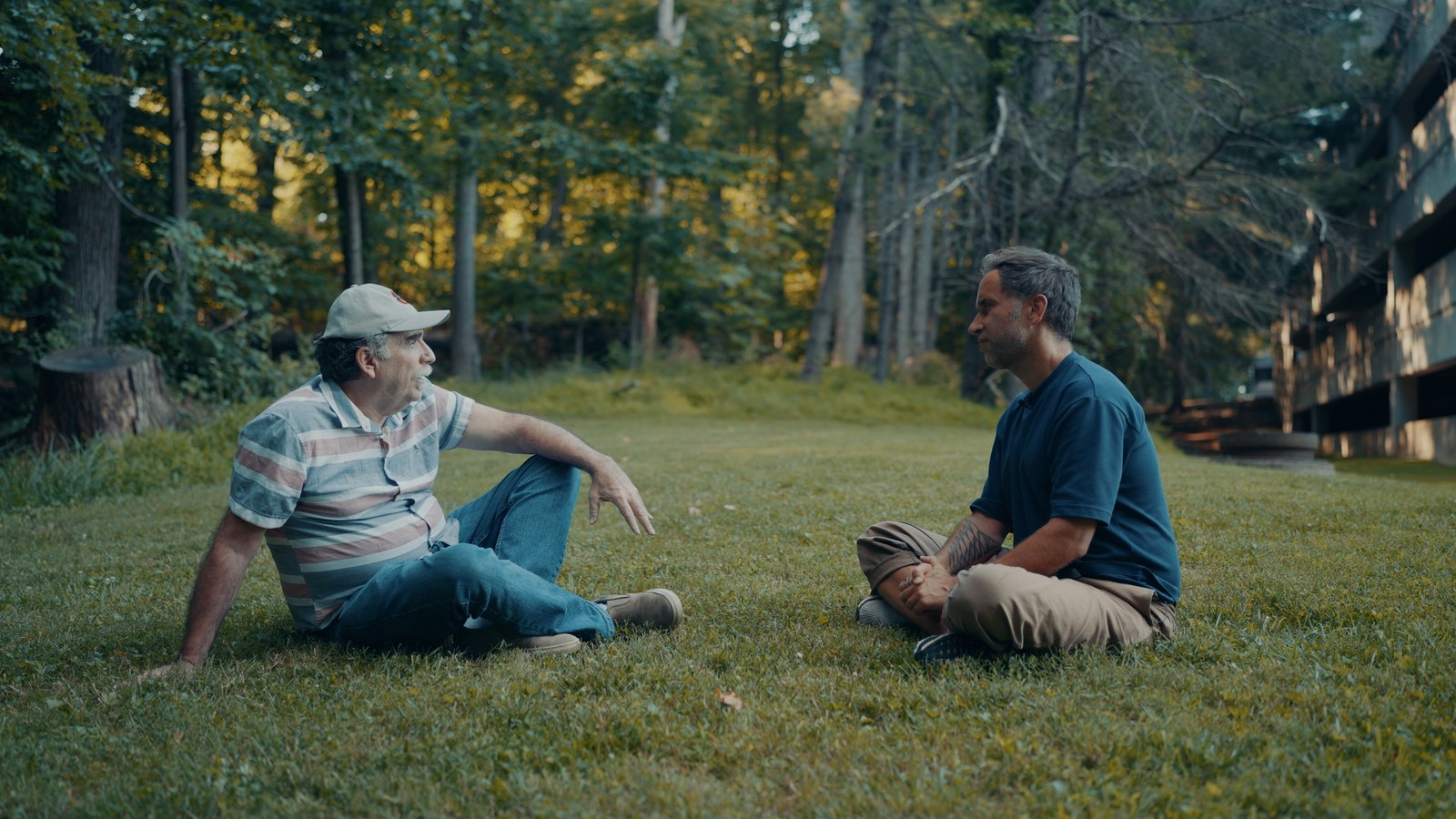 Larry Callahan and Marek Piotrowski sitting on the grass in Washington during the Live Beyond interview