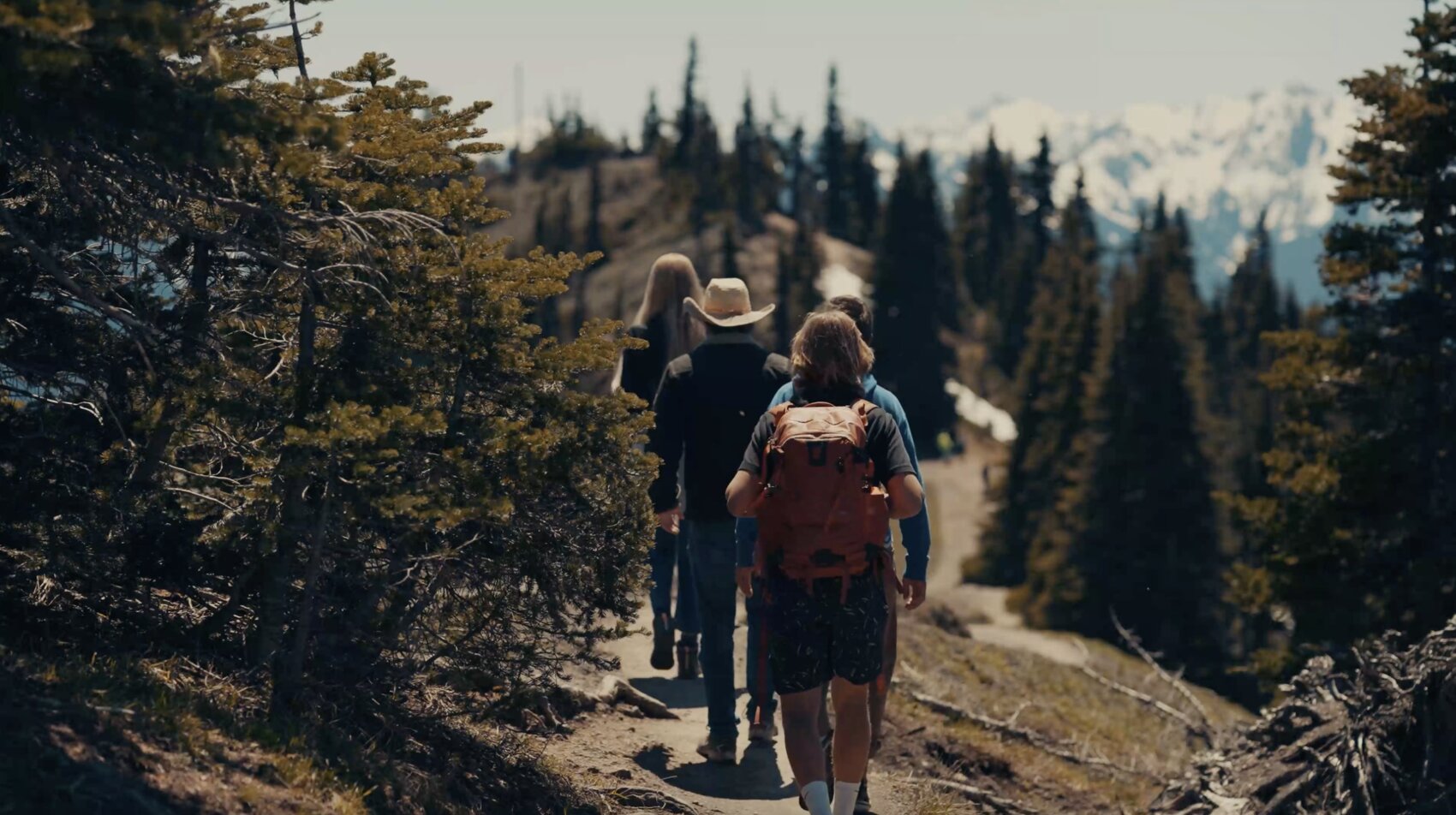 Liz Parrish, her husband, Marek and Aleksander hiking a mountain trail together