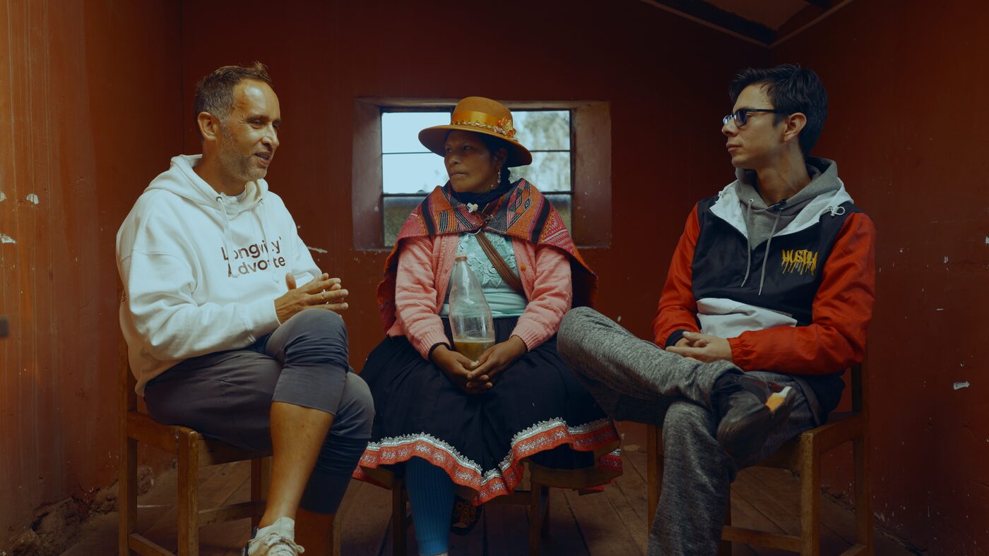 Maestra Lucia sitting with Marek and the translator during the interview near Cusco