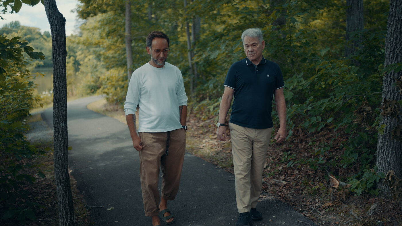 Marek and Dave Gobel walking a wooded path in Washington