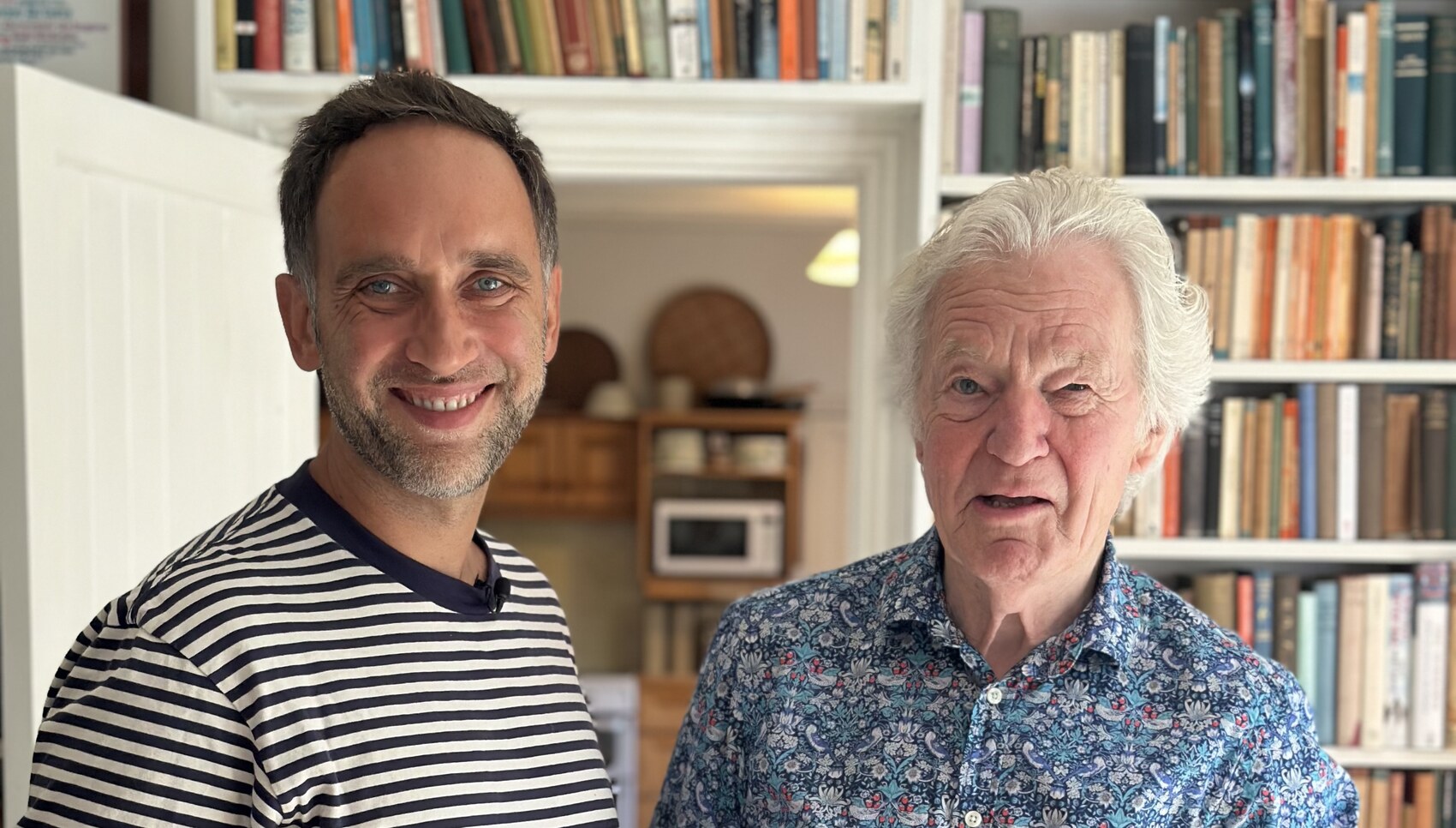 Marek and Sir Muir Gray smiling together in the library in Oxford after the interview