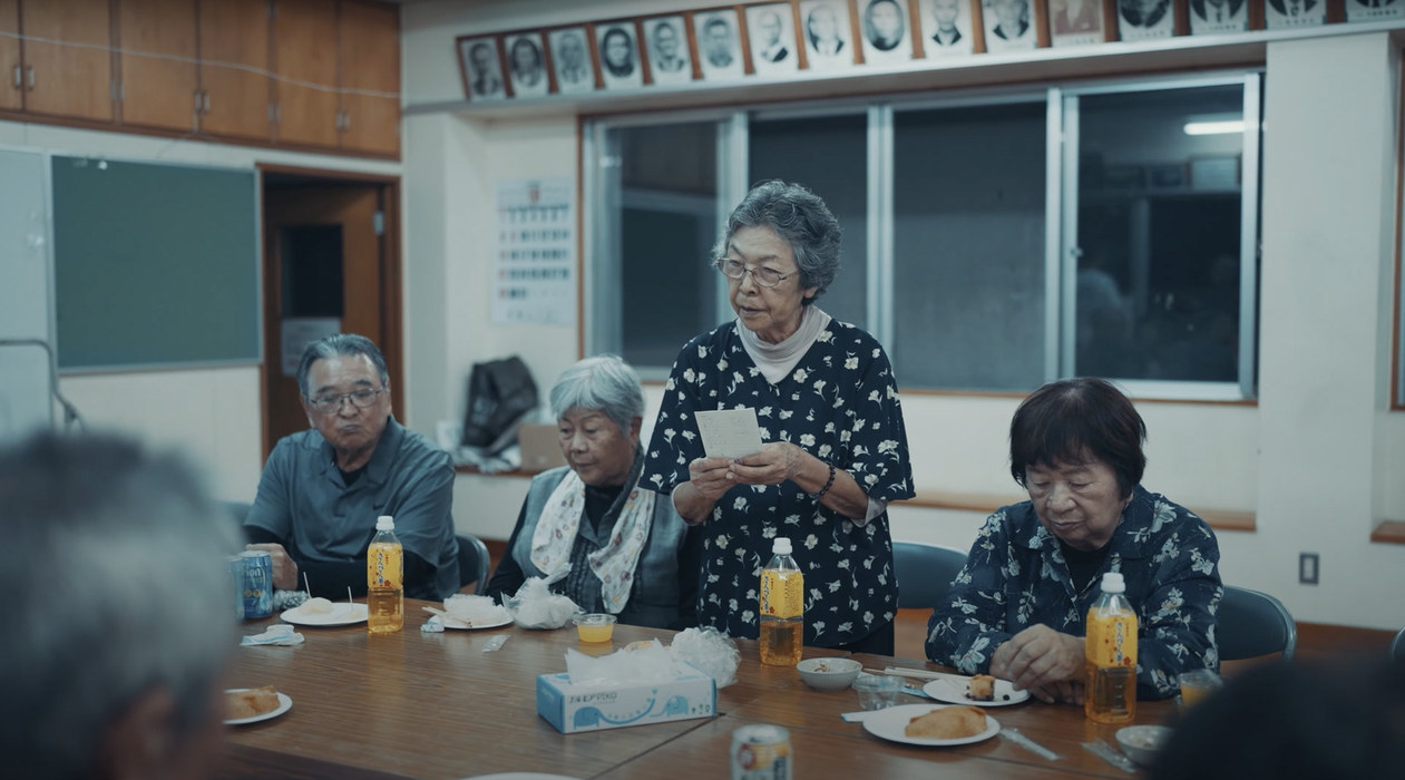 Elderly residents of Ogimi sitting together at a table in the village community centre