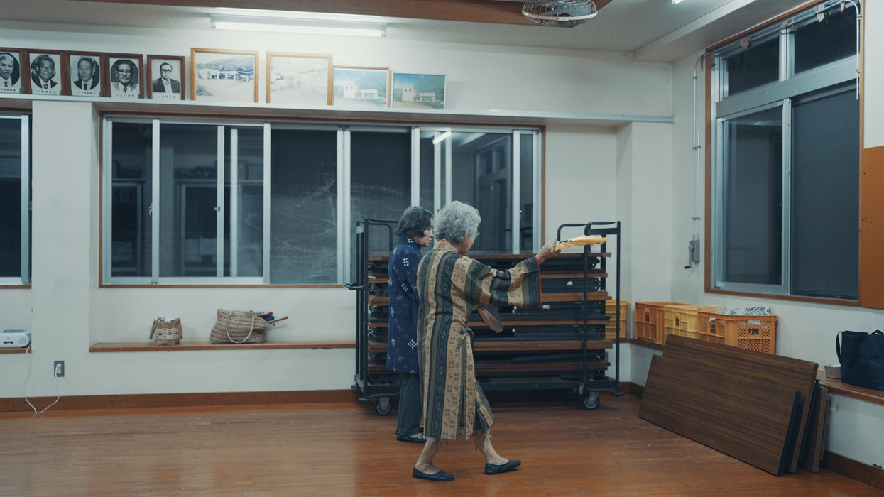 An elderly resident of Ogimi in the village community hall