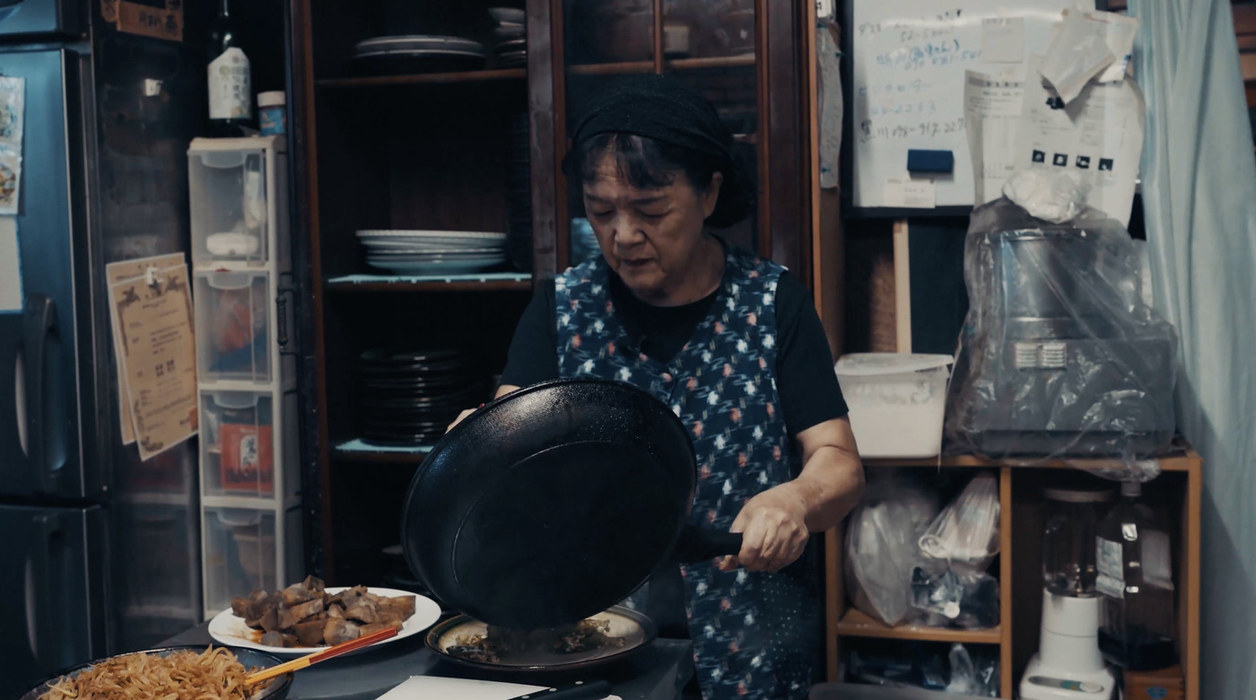 Emi-san cooking in the kitchen of Emi no Mise, Ogimi, Okinawa
