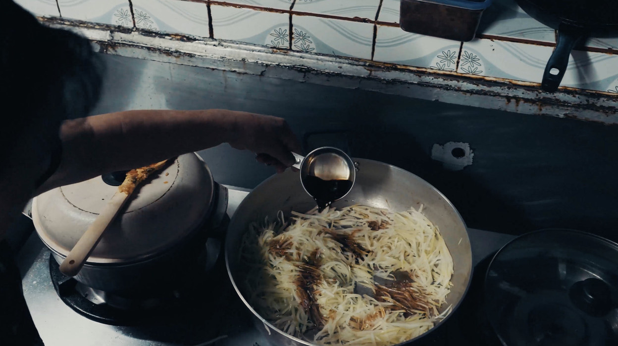 Shredded green papaya cooking in a pan at Emi no Mise, Ogimi, Okinawa