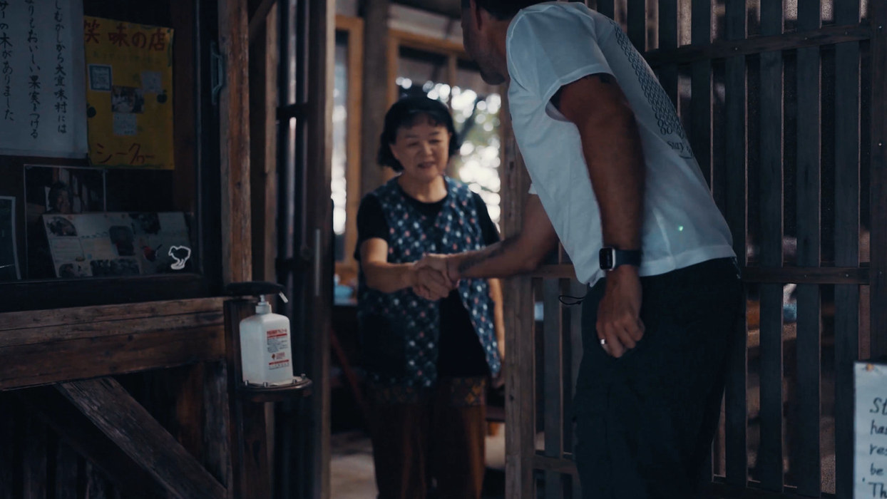 Emi-san welcoming Marek Piotrowski at the door of Emi no Mise, Ogimi, Okinawa