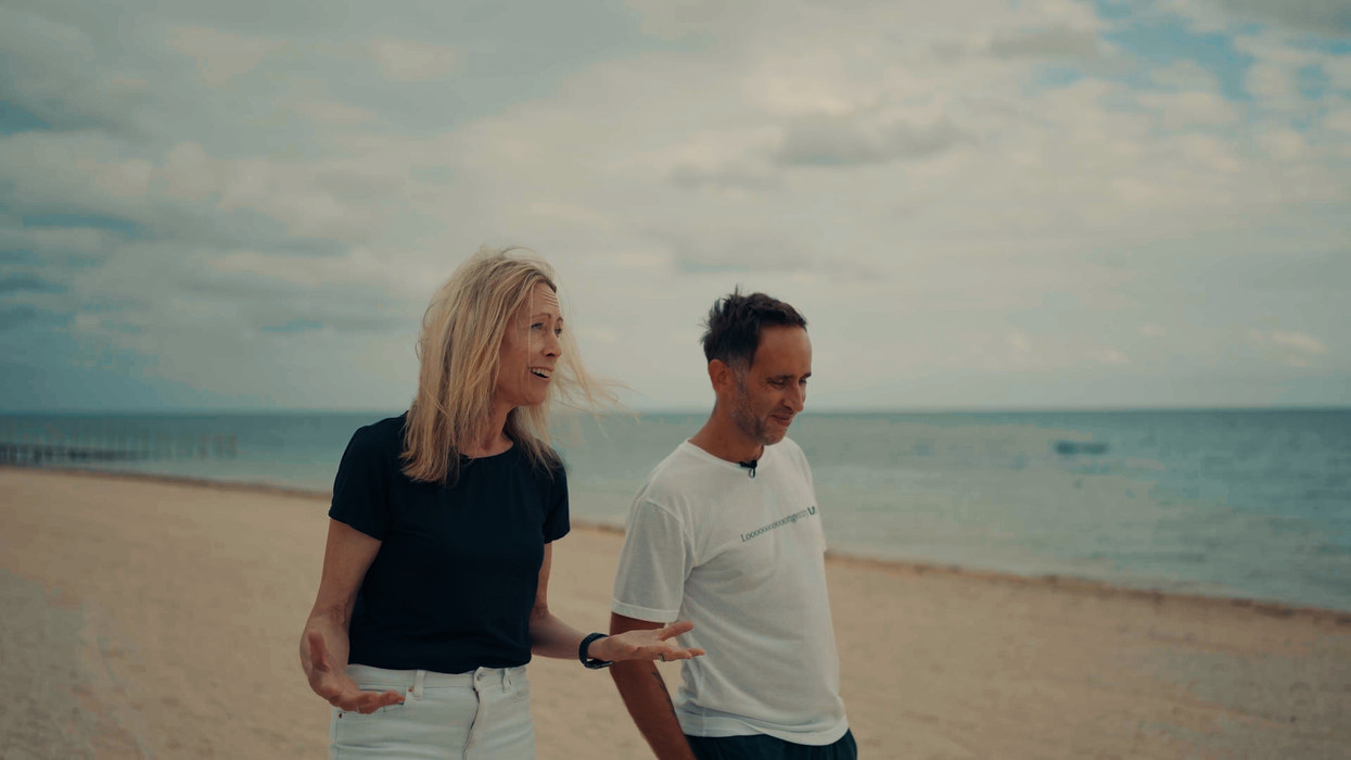 Tina Woods walking on the beach with Marek Piotrowski in Okinawa