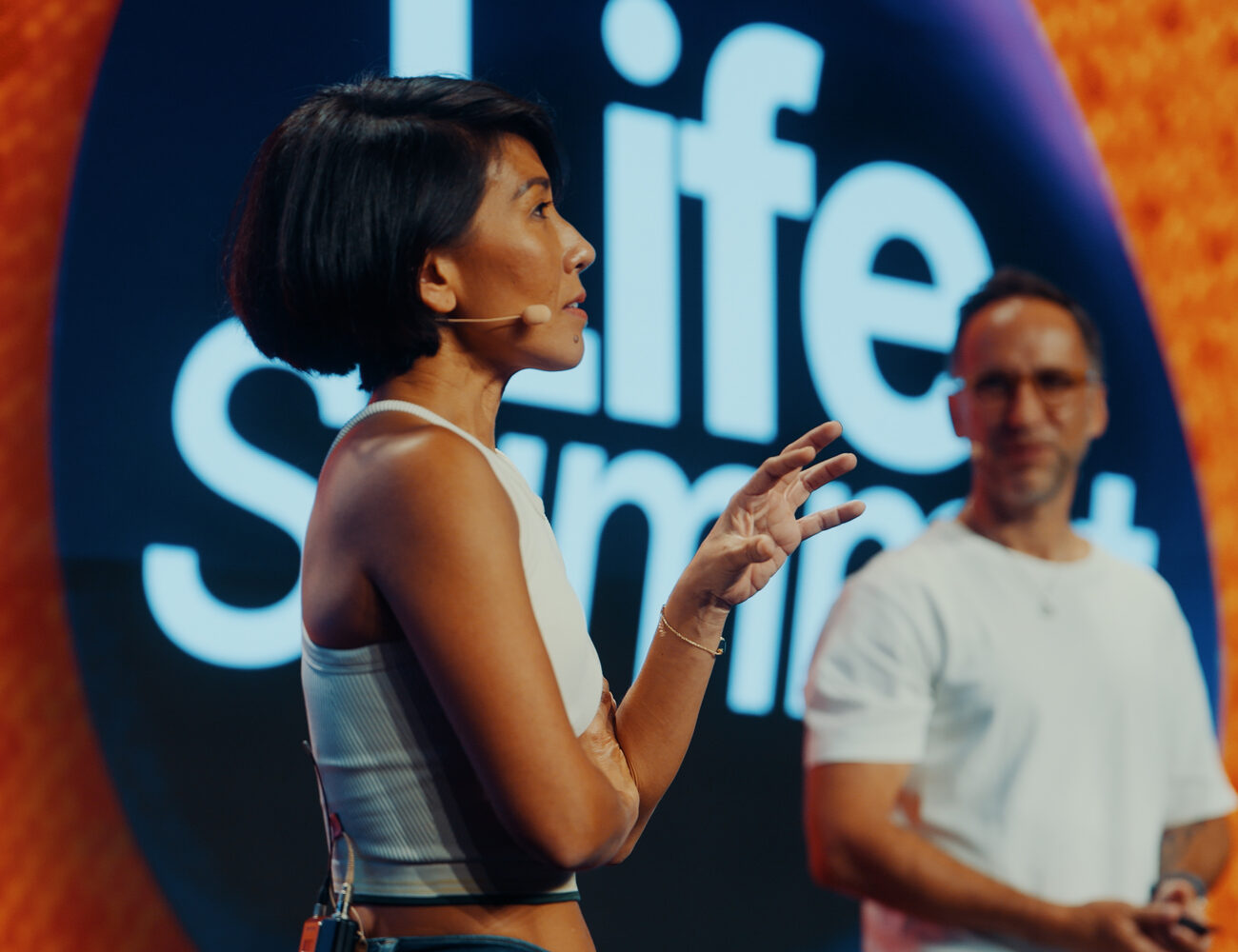 Olivia Lesslar and Marek Piotrowski on stage at LifeSummit