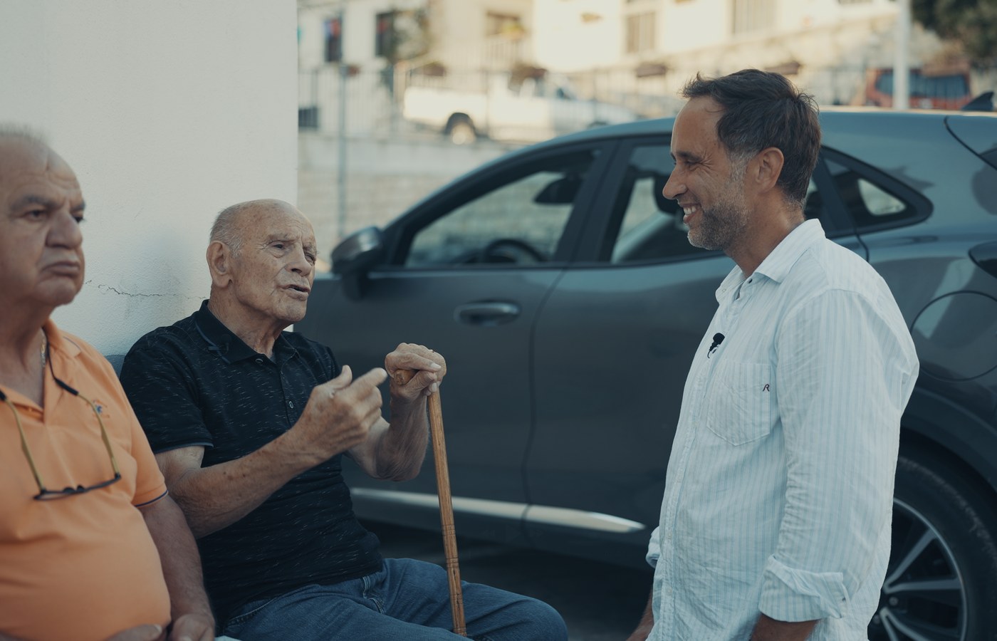 Marek talking with two Sardinian elders, one holding a cane