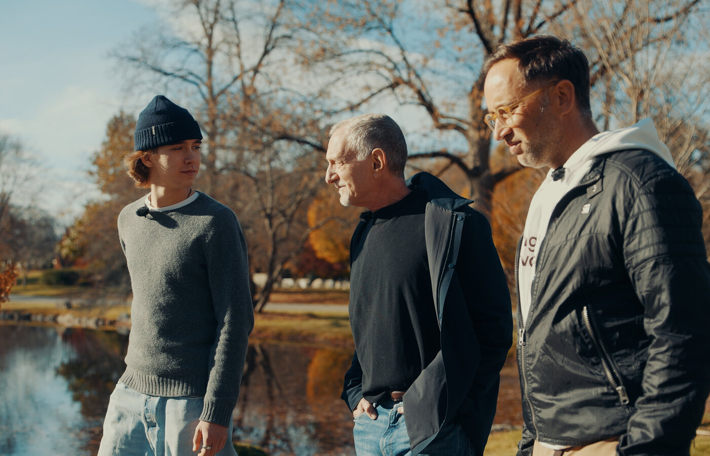 Robert Waldinger walking with Marek and Aleksander by a pond in Boston