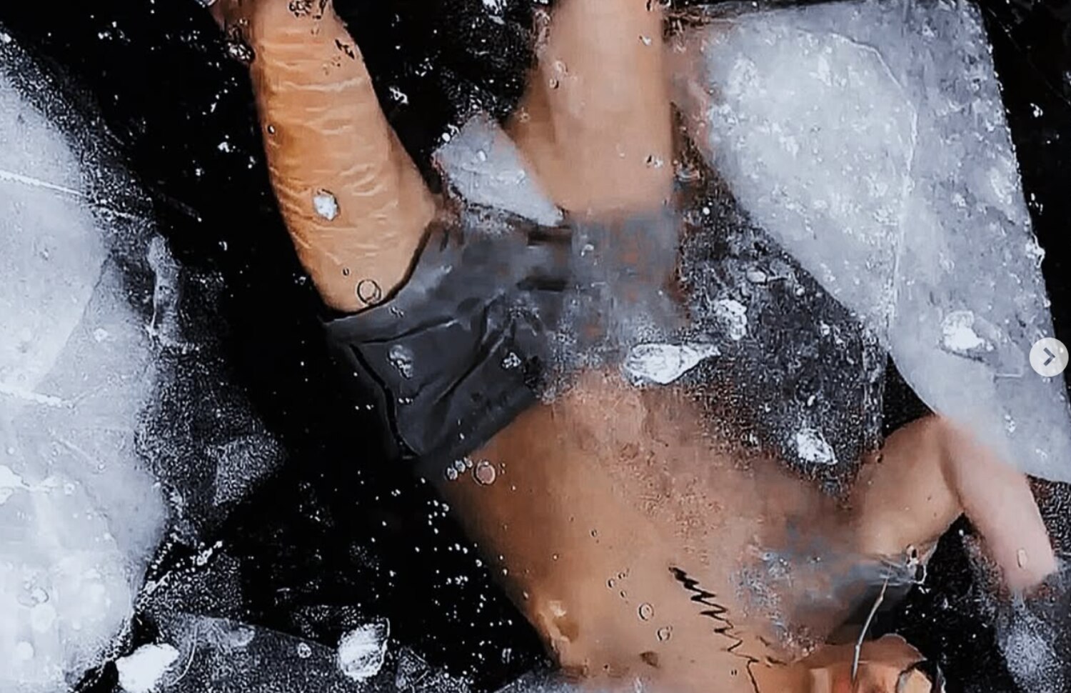 Ron Batuigas mid cold-plunge among broken lake ice