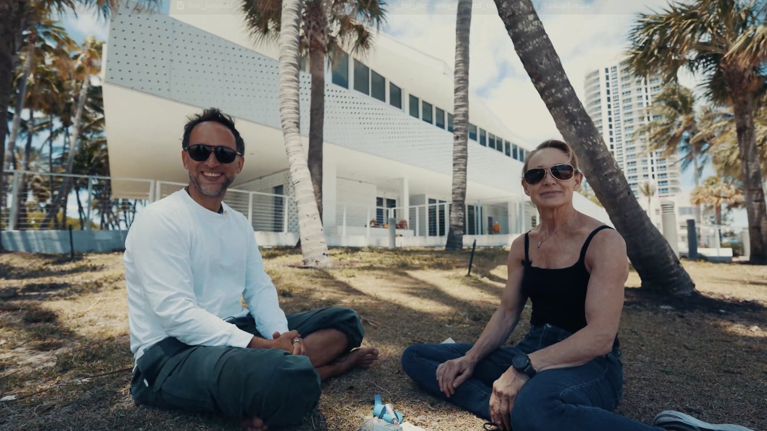 Sandra Kaufmann sitting in a Miami park with Marek Piotrowski during the Live Beyond interview