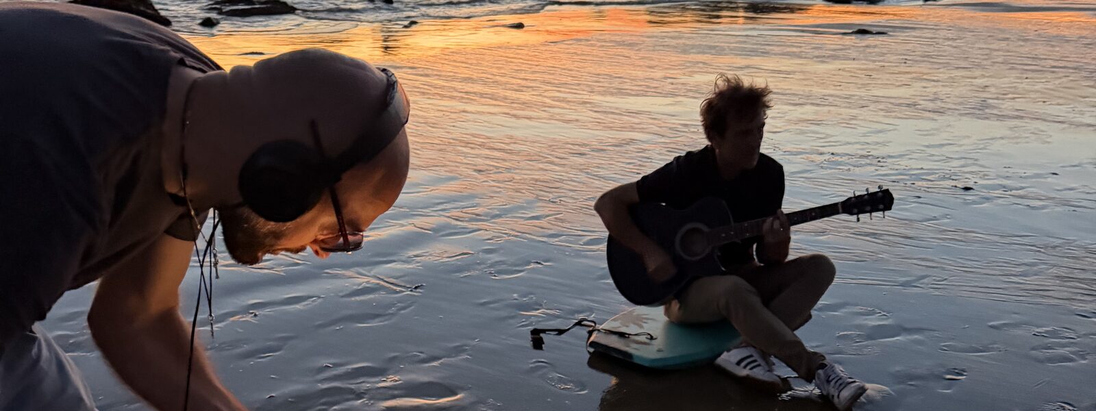 Vittorio Sebastiano playing guitar on the beach at sunset, California