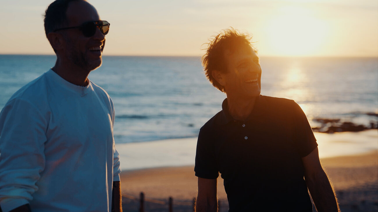Marek and Vittorio Sebastiano talking at sunset on the beach in Irvine